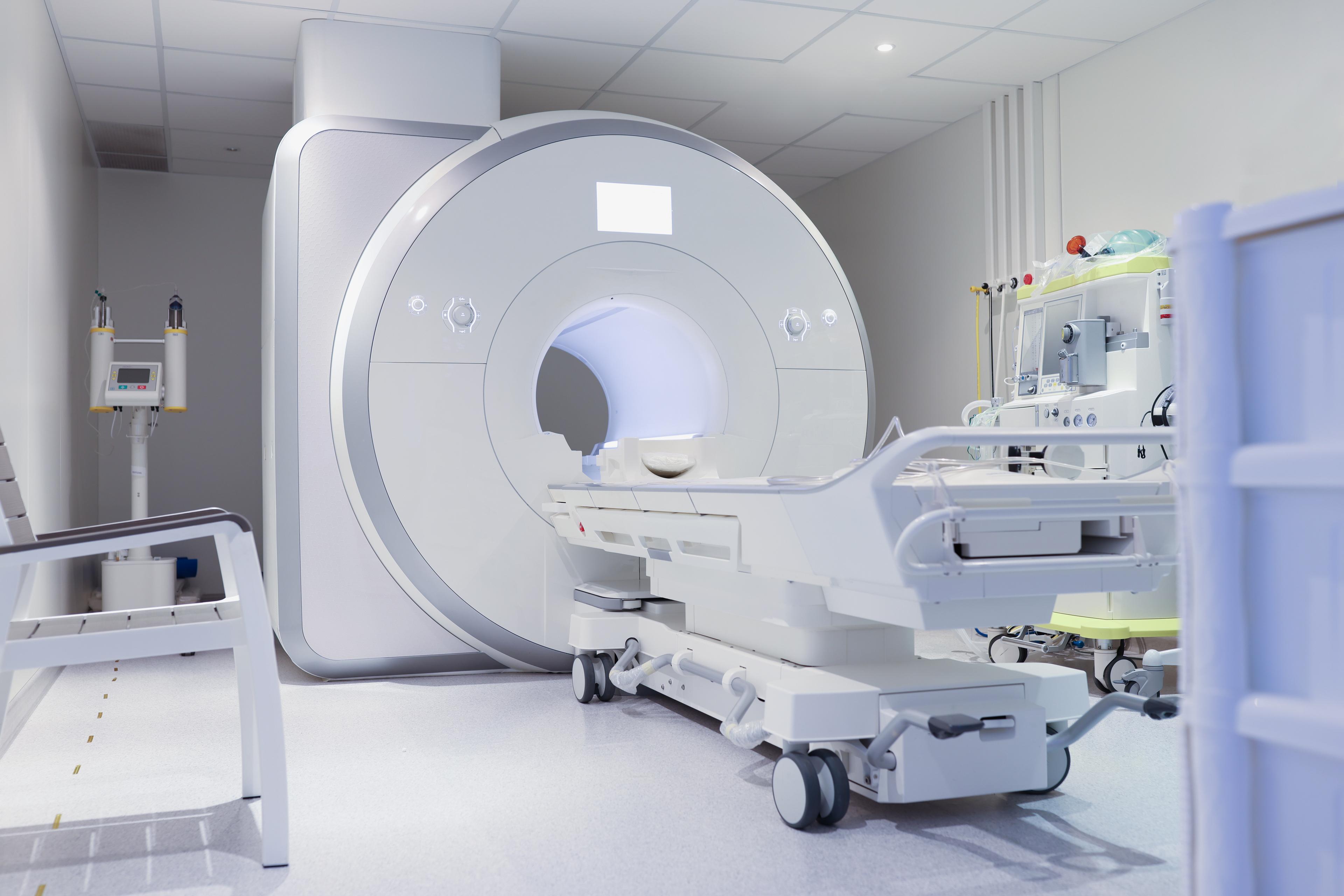 MRI Service: MRI scanner room with patient table and clinical equipment